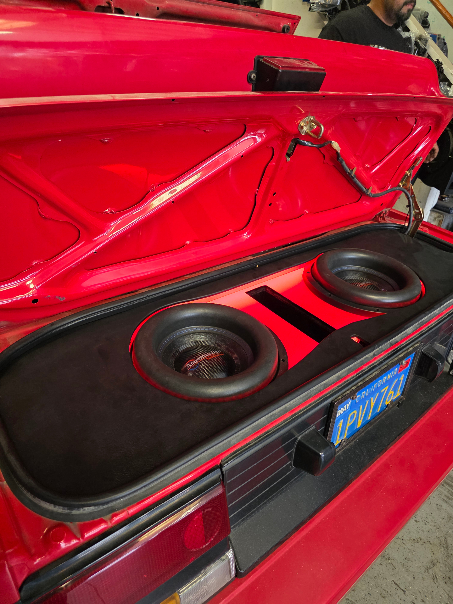 Dual American Bass subwoofers in a custom trunk enclosure